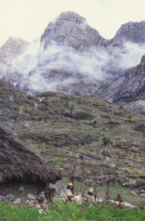 COLOMBIA, Santa Marta, Sierra Nevada , "Two Ica Indian brothers talking, with hut and mountains