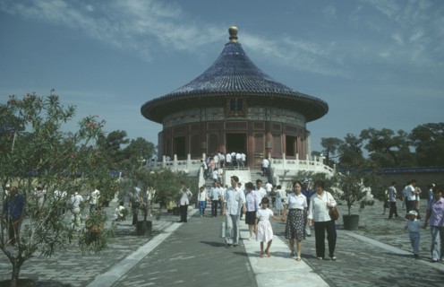 CHINA, Hebei, Beijing, Temple of Heaven with Chinese tourists walking on path.