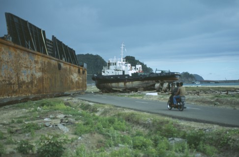INDONESIA, Tsunami, Aceh Province, Two large metal ships dumped on middle of a road outside Banda