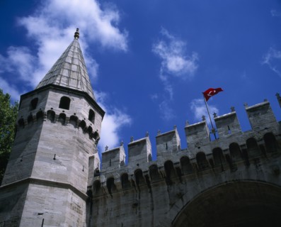 TURKEY, Istanbul, "Topkapi Palace. Entrance to grounds looking up at a tower, crenelated wall and