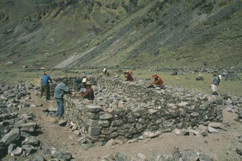 PERU, Cusco, Cancha Cancha, Local Quechuan men building a house.