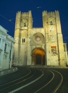 PORTUGAL, Lisbon, Alfama.  Se Cathedral exterior facade at night with two castellated bell towers