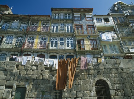 PORTUGAL, Porto, Oporto, Washing hanging from walls and balconies of waterfront houses in the