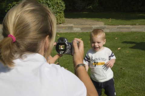 MEDIA , Cameras, Digital, Mother taking a digital photograph of her son