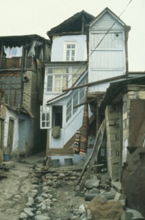 RUSSIA, Dagestan, Narrow street with central open drain and traditional housing.