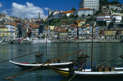 PORTUGAL, Porto, Oporto, The River Douro and waterside buildings with port barges or barcos rabelos