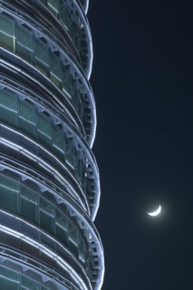 MALAYSIA, Peninsular, Kuala Lumpur, Detail of the Petronis Towers at night with a crescent moon