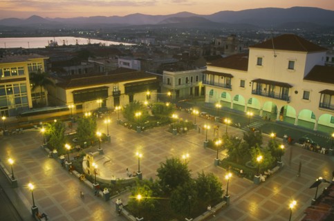 CUBA, Santiago de Cuba, Parque Cespedes at night.  Elevated view over paved square and surrounding