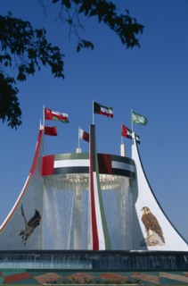 UAE, Abu Dhabi, Falcon Fountain with flags flying on top. Part of the Hotel Intercontinental
