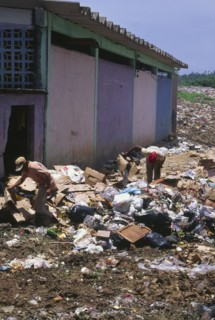 COLOMBIA, San Andres, "Two people searching through rubbish, waste collection site."