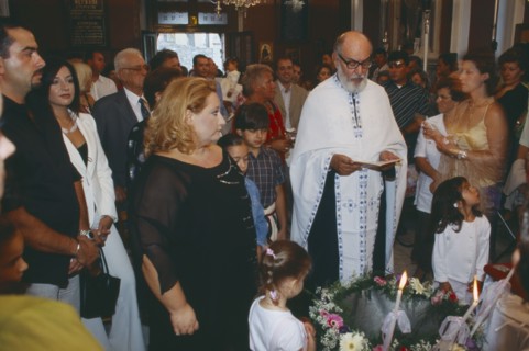 GREECE, Cyclades Islands, Syros, "A Greek orthodox christening, The Priest reads with friends and