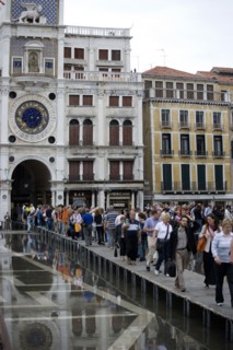 ITALY, Veneto, Venice, Aqua Alta High Water flooding in St Marks Square with tourists walking on