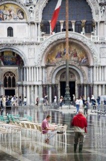 ITALY, Veneto, Venice, Aqua Alta High Water flooding in St Marks Square showing St Marks Basilica