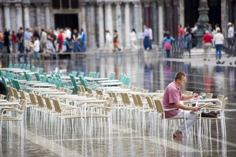 ITALY, Veneto, Venice, Aqua Alta High Water flooding in St Marks Square showing St Marks Basilica