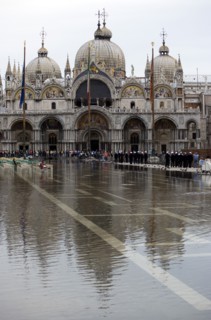 ITALY, Veneto, Venice, Aqua Alta High Water flooding in St Marks Square showing St Marks Basilica