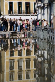 ITALY, Veneto, Venice, Aqua Alta High Water flooding in St Marks Square with tourists queuing on