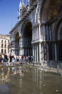 ITALY, Veneto, Venice, Aqua Alta High Water flooding in St Marks Square with tourists queuing on