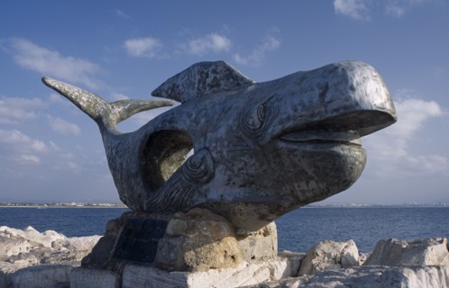ISRAEL, Acre, A giant sculpture of a whale with the sea in the background