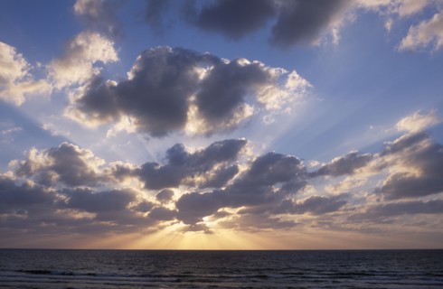 ISRAEL, Landscape, Sunset  with the sun behind a dramatic cloud formation over the Mediterranean