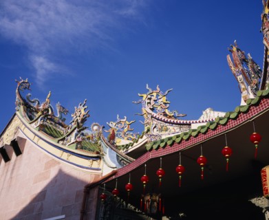 MALAYSIA, Penang, Georgetown, Chinese temple roof hung with red lanterns for Chinese New Year.