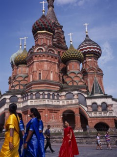RUSSIA, Moscow, St Basil’s Cathedral exterior with women in brightly coloured saris in the