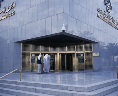 KUWAIT, Kuwait City, Exterior of Al-Ahli Bank of Kuwait with two men about to enter.