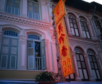 SINGAPORE, Chinatown, Renovated old colonial facades with orange neon sign in Chinese script.