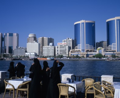 UAE, Dubai, Dubai Creek.  Women in waterfront restaurant on Bur Dubai city side looking out towards