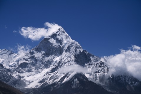 NEPAL, Himalayas, Khumbu Region, Mount Ama Dablam.  Snow covered peak of west face in drifting