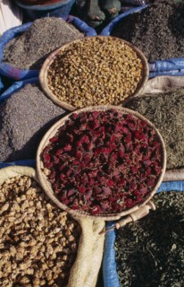 MOROCCO, Marrakech, Baskets of dried flower heads and leaves for sale at market.