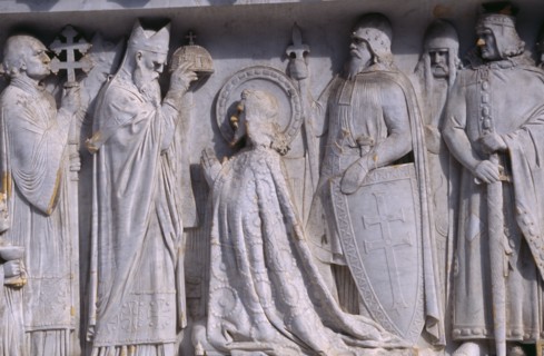 HUNGARY, Budapest, Detail of stone relief carving depicting a coronation on plinth of the