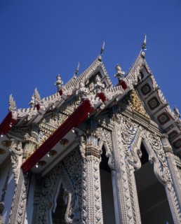 THAILAND, Bangkok, Sathorn District, Charoen Krung.  Highly decorated temple rooftop on Chao Phraya