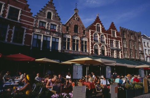 BELGIUM, West Flanders, Bruges, The Markt (Market Place)  Line of cafes with busy outside tables