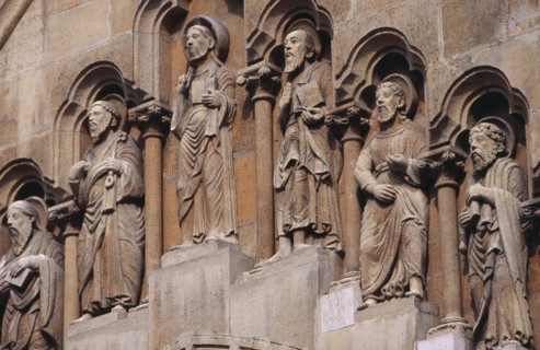 HUNGARY, Budapest, Benedictine Abbey of Jak. Detail of carved religious figures over stone archway.