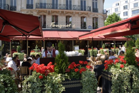 FRANCE, Ile de France, Paris, Fouquet's brasserie on the Champs Elysees with waiter and customers