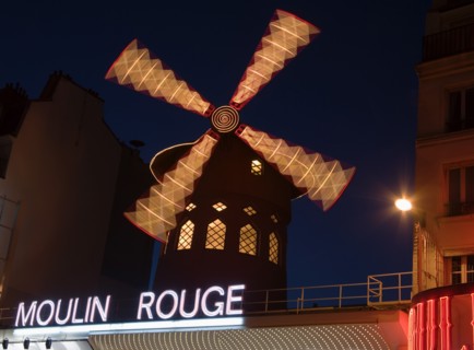 FRANCE, Ile de France, Paris, Montmartre The Moulin Rouge nightclub illuminated at night with the
