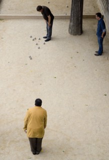 FRANCE, Ile de France, Paris, "Three men playing Boules, or Petanque, beside the River Seine"