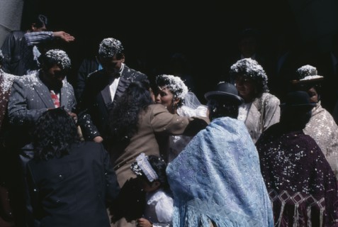 BOLIVIA, La Paz, Friends and family congratulate wedding bride and groom covered with white