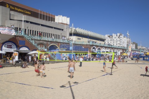 ENGLAND, East Sussex, Brighton, People playing beach volleybal on the sands in front of the