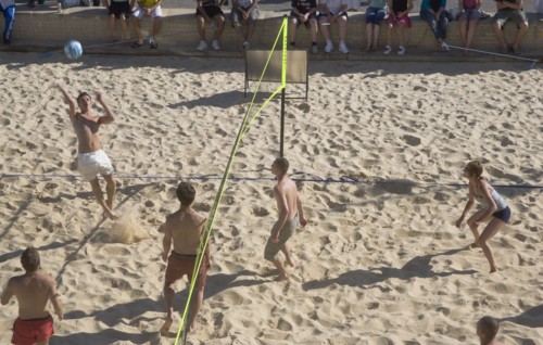ENGLAND, East Sussex, Brighton, Beach volleyball game on the sands in front of the Grand Hotel.