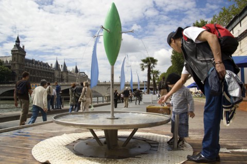 FRANCE, Ile de France, Paris, "The Paris Plage urban beach. A small boy with an adult at one of the