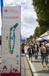 FRANCE, Ile de France, Paris, The Paris Plage urban beach. People strolling beside the River Seine