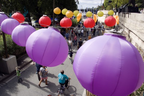 FRANCE, Ile de France, Paris, The Paris Plage urban beach. Colourful lanterns hanging above