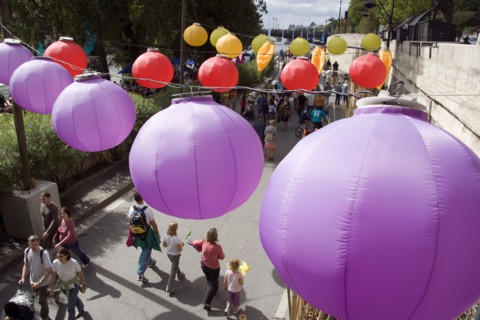 FRANCE, Ile de France, Paris, The Paris Plage urban beach. Colourful lanterns hanging above