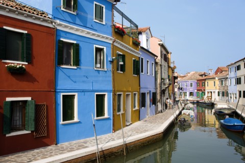 ITALY, Veneto, Venice, Colourful houses beside a canal on the lagoon island of Burano with tourists
