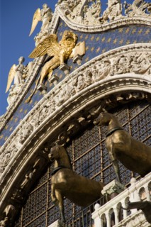 ITALY, Veneto, Venice, The bronze Horses of St Mark and the winged Lion of St Mark below Angels on