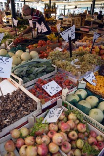 ITALY, Veneto, Venice, Fruit and vegetable stall in the Rialto market with vendor working
