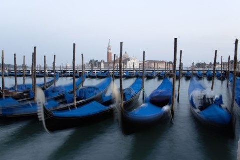 ITALY, Veneto, Venice, Gondolas moored at dusk in the Molo San Marco basin with Palladio's church
