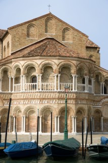 ITALY, Veneto, Venice, The colonnaded exterior of the Basilica dei Santa Maria e Donato with boats