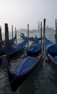 ITALY, Veneto, Venice, A gondolier works his gondola past others moored at the Molo San Marco with